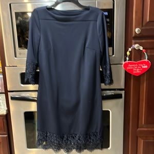 Women’s navy dress with lace on sleeves and bottom
